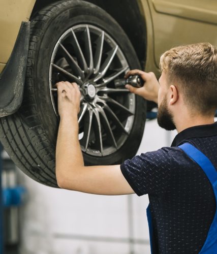 car mechanic trying set socket auto wheel