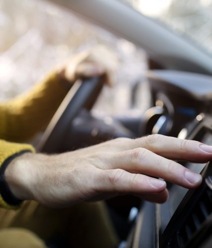 close up hand holding steering wheel